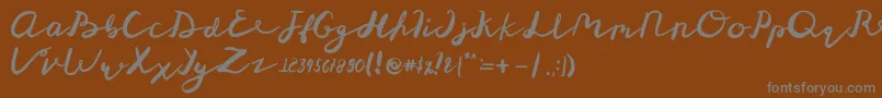 St Maknyus-Schriftart – Graue Schriften auf braunem Hintergrund