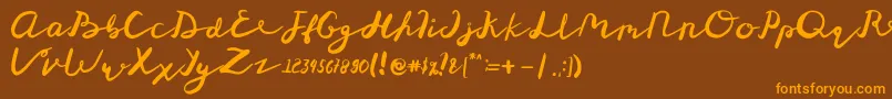 フォントSt Maknyus – オレンジ色の文字が茶色の背景にあります。
