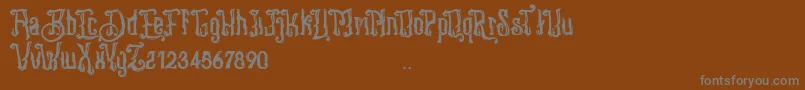 Stangbunder-fontti – harmaat kirjasimet ruskealla taustalla