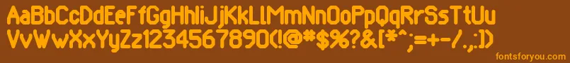 フォントPomcute – オレンジ色の文字が茶色の背景にあります。