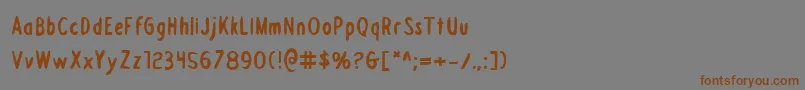 フォントDraftingboardb – 茶色の文字が灰色の背景にあります。