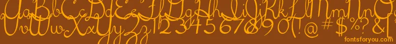 5thgradecursive2-Schriftart – Orangefarbene Schriften auf braunem Hintergrund