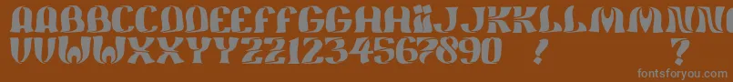 JmhFeliz-fontti – harmaat kirjasimet ruskealla taustalla