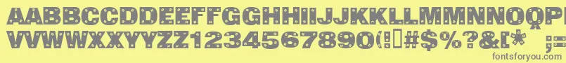 Sansplatecaps-fontti – harmaat kirjasimet keltaisella taustalla