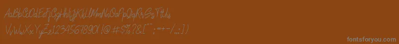 Fonte LinoleoScript – fontes cinzas em um fundo marrom