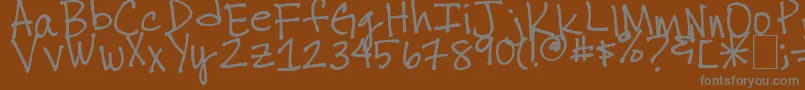 Thuyschickenscratch-fontti – harmaat kirjasimet ruskealla taustalla