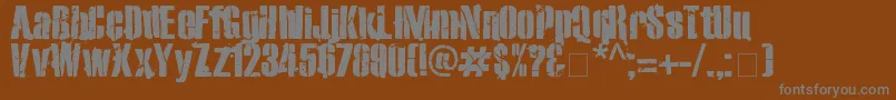 Exo2Stencil-fontti – harmaat kirjasimet ruskealla taustalla
