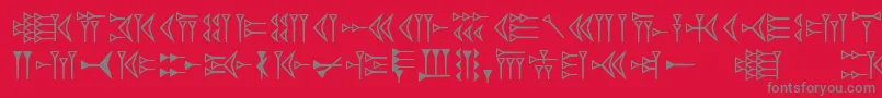 Czcionka Easycuneiform – szare czcionki na czerwonym tle