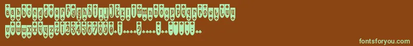 フォントPopuluxeBlub – 緑色の文字が茶色の背景にあります。