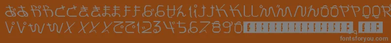 PrayForJapan-fontti – harmaat kirjasimet ruskealla taustalla