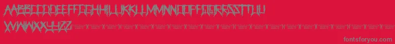 フォントThegrinderRegular – 赤い背景に灰色の文字