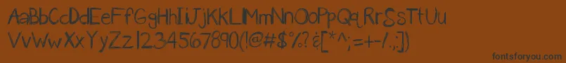 Kbanavoxlost-Schriftart – Schwarze Schriften auf braunem Hintergrund