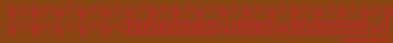 フォントJackintheboxKg – 赤い文字が茶色の背景にあります。