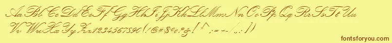 フォントKunstlerScript – 茶色の文字が黄色の背景にあります。