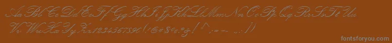 KunstlerScript-Schriftart – Graue Schriften auf braunem Hintergrund