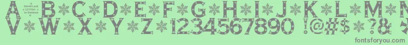 SnowflakeLetters Font – Gray Fonts on Green Background