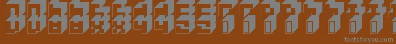 3x3Block-fontti – harmaat kirjasimet ruskealla taustalla