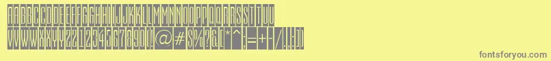 EmpirialcmRegular-fontti – harmaat kirjasimet keltaisella taustalla