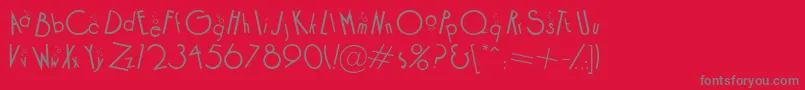 CocktailBubbly-fontti – harmaat kirjasimet punaisella taustalla