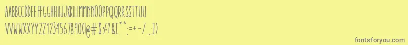 フォントAracneUltraCondensedRegular – 黄色の背景に灰色の文字