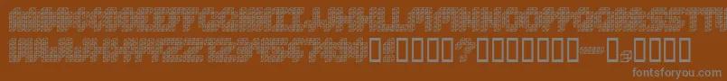CubeToss-fontti – harmaat kirjasimet ruskealla taustalla