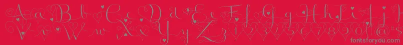 BadinerieLovedemo-Schriftart – Graue Schriften auf rotem Hintergrund