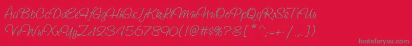 StudioScriptItcTt-Schriftart – Graue Schriften auf rotem Hintergrund