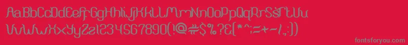 ArunaAiraJasmine-Schriftart – Graue Schriften auf rotem Hintergrund
