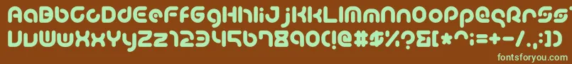 フォントTeacherA – 緑色の文字が茶色の背景にあります。