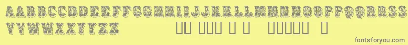 Azteak-fontti – harmaat kirjasimet keltaisella taustalla