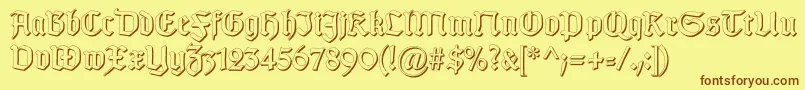 フォントGotischSchatten – 茶色の文字が黄色の背景にあります。
