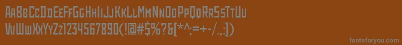 RodchenkoCondensed-fontti – harmaat kirjasimet ruskealla taustalla