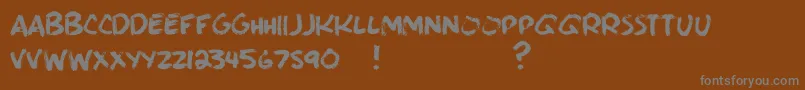 BrushieBrushie-Schriftart – Graue Schriften auf braunem Hintergrund