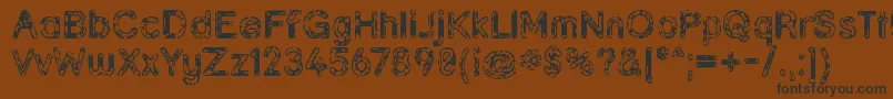 フォントGrunja ffy – 黒い文字が茶色の背景にあります