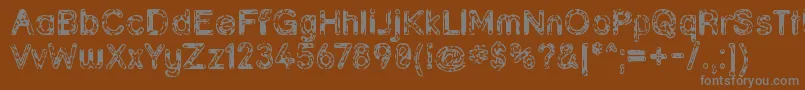 Grunja ffy-fontti – harmaat kirjasimet ruskealla taustalla