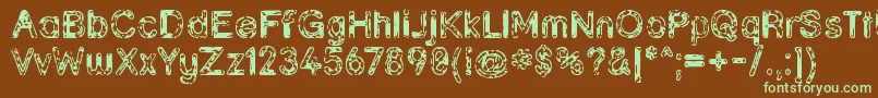 フォントGrunja ffy – 緑色の文字が茶色の背景にあります。