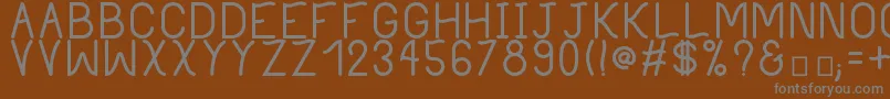 PhilippineBold-fontti – harmaat kirjasimet ruskealla taustalla