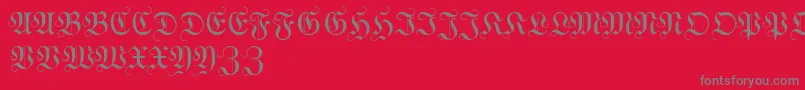 WittewittmajusclesFlourish-fontti – harmaat kirjasimet punaisella taustalla