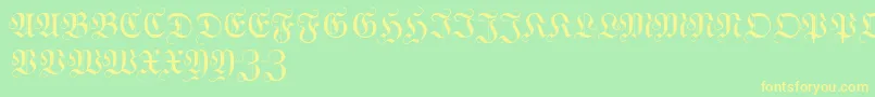 フォントWittewittmajusclesFlourish – 黄色の文字が緑の背景にあります