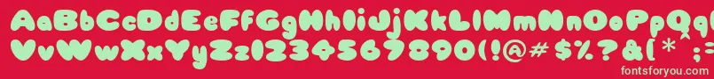 Weitere Informationen zur Babycake-Schriftart Babycake-Schriftart – Grüne Schriften auf rotem Hintergrund