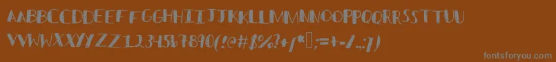 フォントSketched – 茶色の背景に灰色の文字