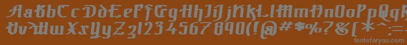 TheBlackBlocBoldItalic-fontti – harmaat kirjasimet ruskealla taustalla
