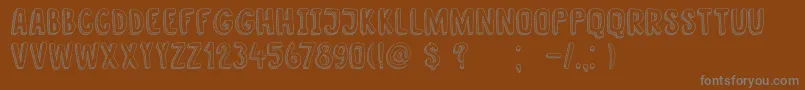 DkNanuk-Schriftart – Graue Schriften auf braunem Hintergrund