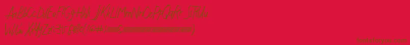 Justwritedt-Schriftart – Braune Schriften auf rotem Hintergrund