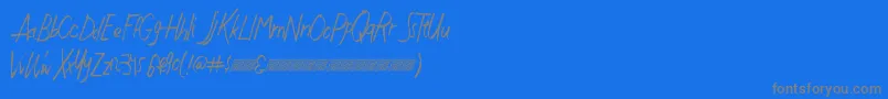 Justwritedt-fontti – harmaat kirjasimet sinisellä taustalla