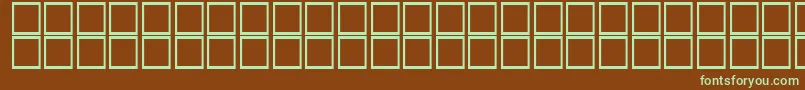 フォントAlDorrh – 緑色の文字が茶色の背景にあります。