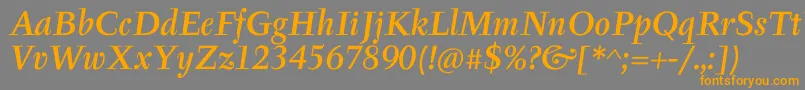 フォントTyfaItcMediumOtItalic – オレンジの文字は灰色の背景にあります。