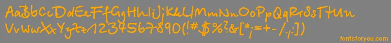 フォントBetinascriptcBold – オレンジの文字は灰色の背景にあります。