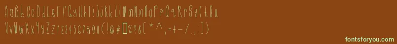 フォントCmonkeelight – 緑色の文字が茶色の背景にあります。