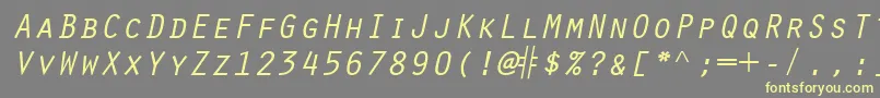 ScribeSsiItalicSmallCaps-fontti – keltaiset fontit harmaalla taustalla